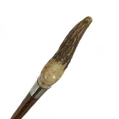 Lot 99 - A white metal mounted child's riding crop with a bone handle.
