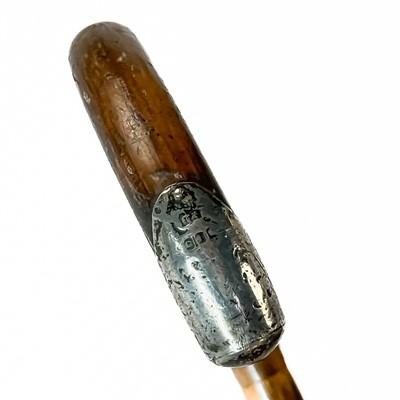 Lot 99 - A white metal mounted child's riding crop with a bone handle.