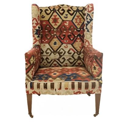 Lot 32 - An early 20th century Kelim upholstered wingback armchair.