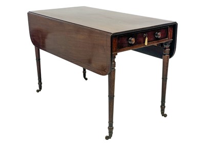 Lot 19 - A late George III figured mahogany and ebony strung Pembroke table.
