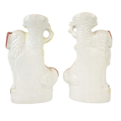 Lot 10 - A pair of Victorian Staffordshire pottery spaniel spill vases.