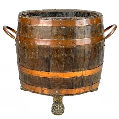 Lot 50 - A copper bound oak barrel form log bin.