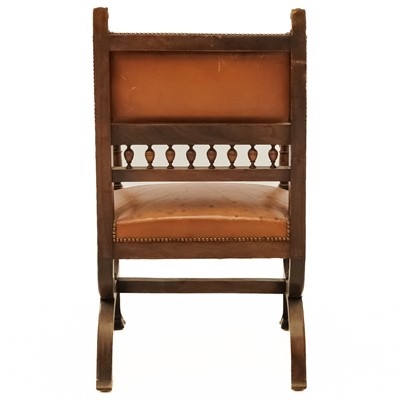 Lot 17 - A late 19th century Italian carved walnut and leather chair.
