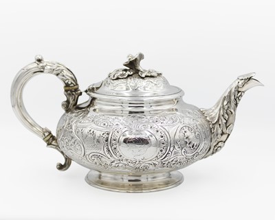 Lot 116 - An early Victorian silver foliate scroll embossed and chased teapot by Charles Gordon.