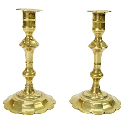 Lot 396 - A pair of 18th century brass candlesticks.