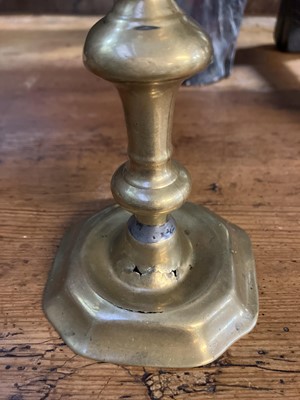 Lot 114 - An 18th century brass candlestick.