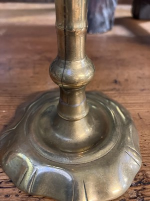 Lot 114 - An 18th century brass candlestick.