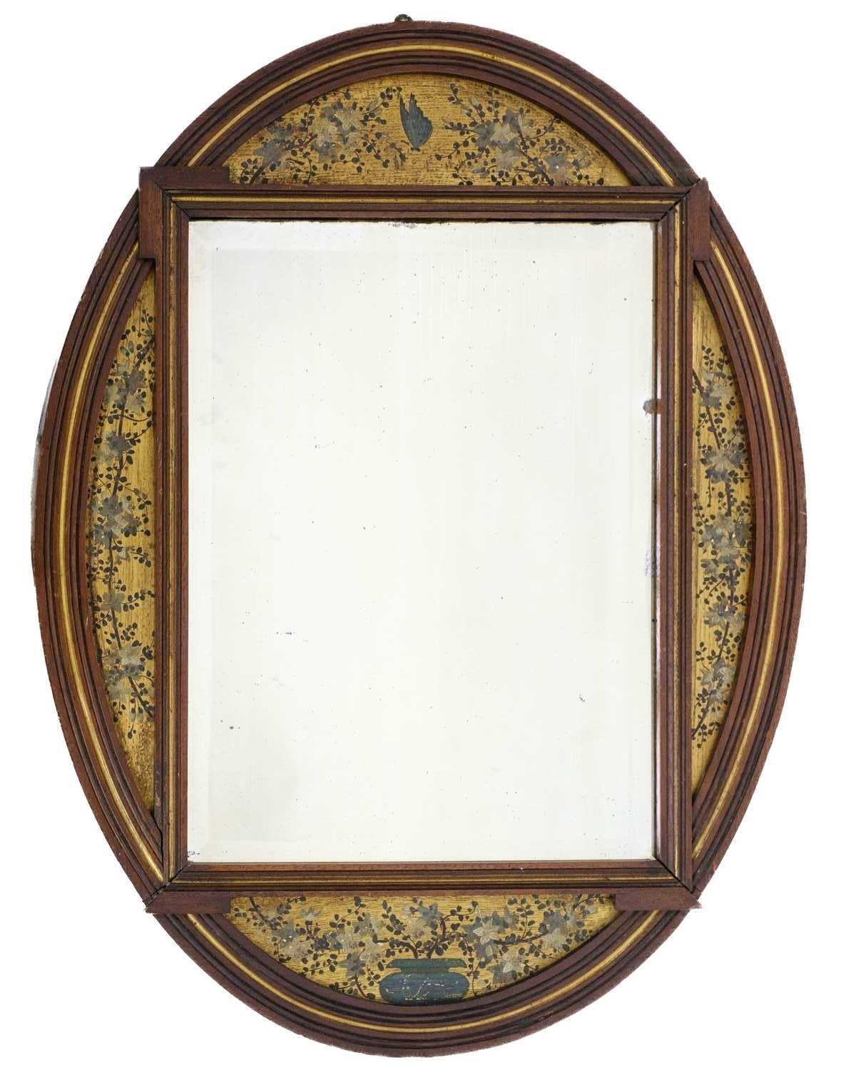 Lot 70 - An Aesthetic Movement mahogany oval frame wall mirror.