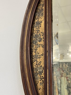 Lot 70 - An Aesthetic Movement mahogany oval frame wall mirror.