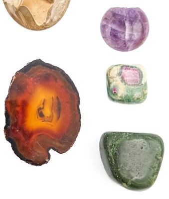 Lot 323 - A large quantity of cut hematite stones with agate and uncut jadeite.