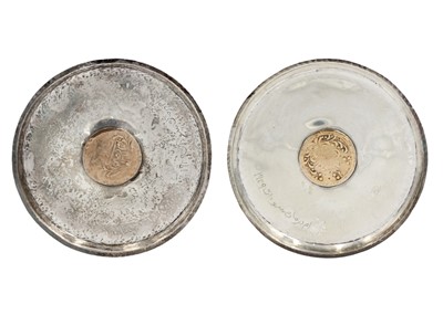 Lot 13 - A pair of Islamic silver .800 coin dishes.