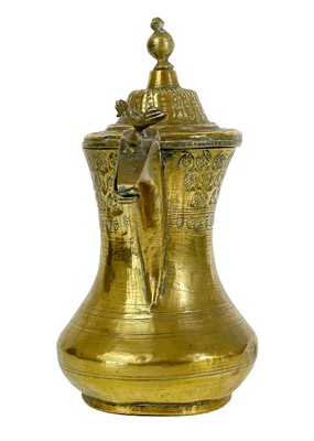 Lot 69 - A Saudi Arabian brass dallah pot, 19th century.