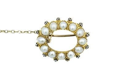 Lot 99 - A 19th century high purity gold pearl and enamel annular brooch.