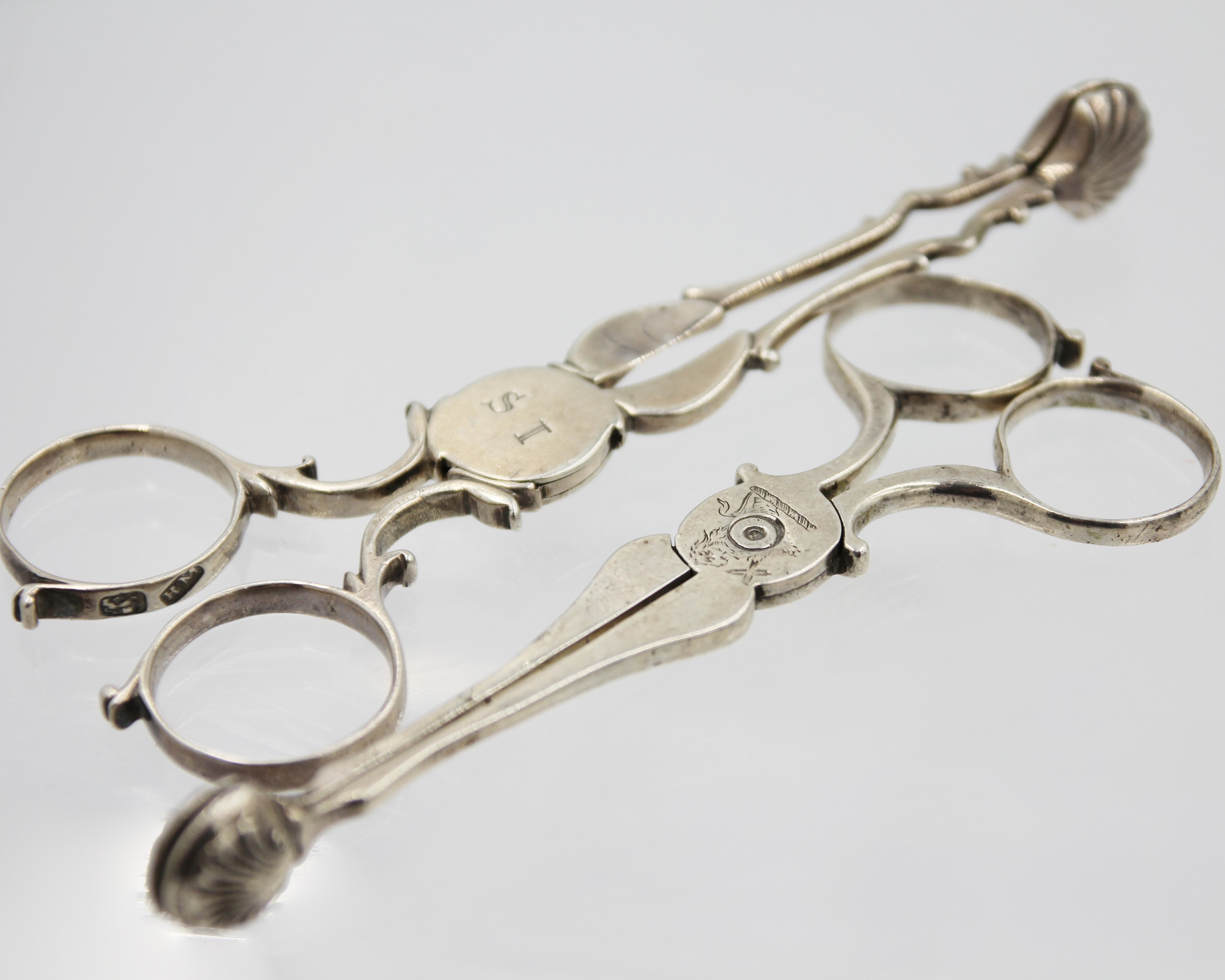 Lot 147 - Two pairs of Georgian silver scissor action