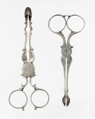 Lot 147 - Two pairs of Georgian silver scissor action sugar nips.