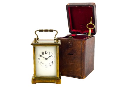 Lot 557 - A French brass carriage clock in fitted leather travel case.