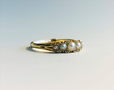 Lot 2579 - A Victorian gold ring set with five pearls and...