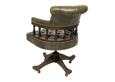 Lot 65 - A button backed green leather captain's swivel chair.