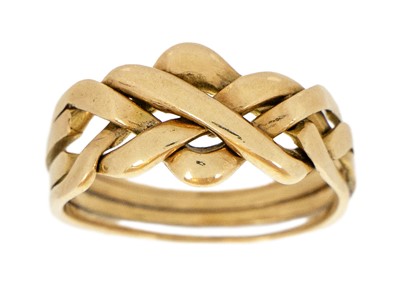 Lot 96 - An 18ct four piece puzzle ring of knot design.