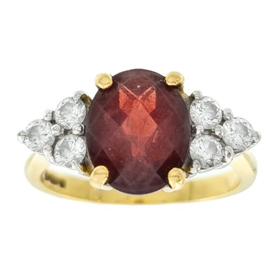 Lot 265 - An 18ct garnet and diamond dress ring.