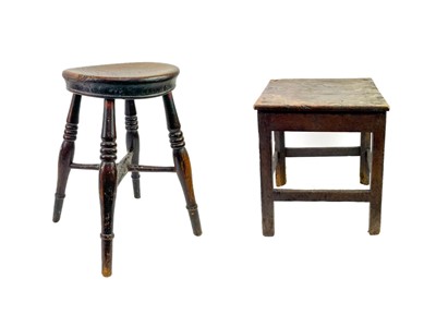 Lot 1183 - A 19th century elm stool with turned supports.