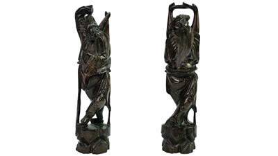 Lot 65 - A pair of Chinese inlaid hardwood figures of immortals, late 19th century.