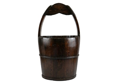 Lot 260 - A stained hardwood oriental bucket.