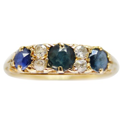 Lot 166 - An 18ct diamond and sapphire set eight-stone ring.