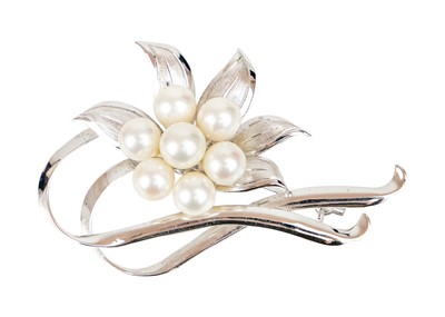 Lot 353 - A silver and cultured pearl floral spray brooch by Mikimoto.