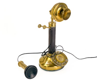 Lot 269 - A brass and leather bound candlestick telephone.