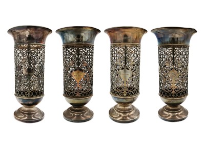 Lot 24 - An Edwardian silver suite of four pierced pedestal vases by James Dixon & Sons.