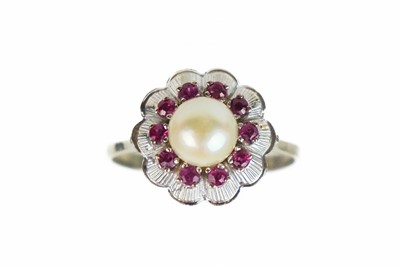 Lot 200 - An 18ct white gold cultured pearl and ruby set cluster flower head design ring.