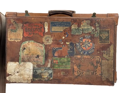 Lot 143 - A large leather suitcase.