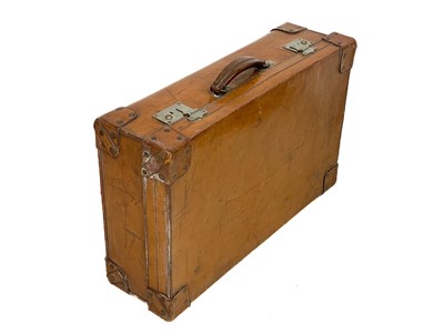 Lot 143 - A large leather suitcase.