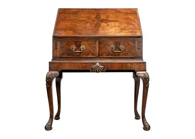 Lot 569 - An early 20th Century walnut bureau.