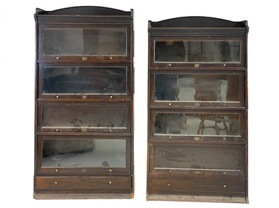 Lot 97 - A matched pair of 20th century oak Lebus sectional bookcases.