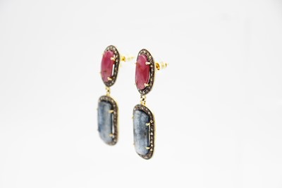 Lot 179 - A silver-gilt pair of rose-cut red and blue sapphire articulated drop earrings.