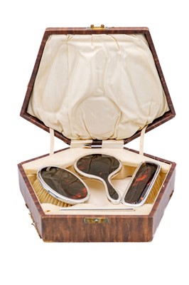 Lot 53 - A cased child's silver and tortoiseshell dressing set by Adie Brothers Ltd.