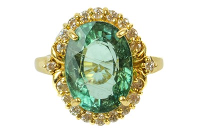 Lot 195 - An 18ct dress ring set with Mozambique paraiba tourmaline and diamonds.