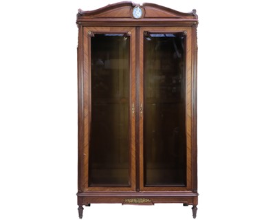 Lot 584 - A French walnut glazed armoire.