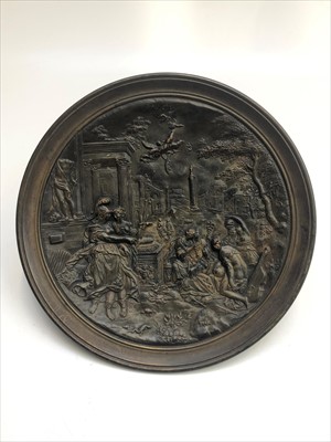 Lot 973 - A bronzed circular ceramic plaque decorated...