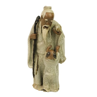 Lot 344 - A Chinese Shiwan figure of a mudman and child, Qing Dynasty, 19th century.