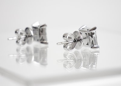 Lot 251 - An 18ct white gold pair of certified princess cut diamond square stud earrings.