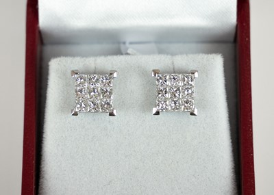 Lot 251 - An 18ct white gold pair of certified princess cut diamond square stud earrings.