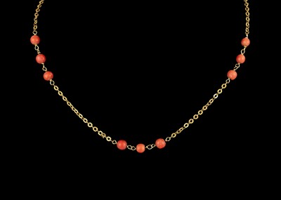 Lot 253 - An 18ct chain and coral bead necklace.