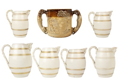 Lot 360 - A set of six 19th century English porcelain barrel mask jugs.