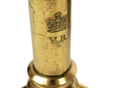 Lot 1099 - A 19th century brass candlestick VR below a crown.
