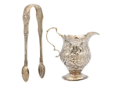 Lot 105 - A George III silver cream jug and a Victorian silver pair of sugar tongs.