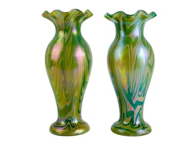 Lot 421 - A pair of Loetz type iridescent glass baluster vases.