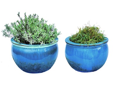 Lot 519 - A pair of blue glazed plant pots.